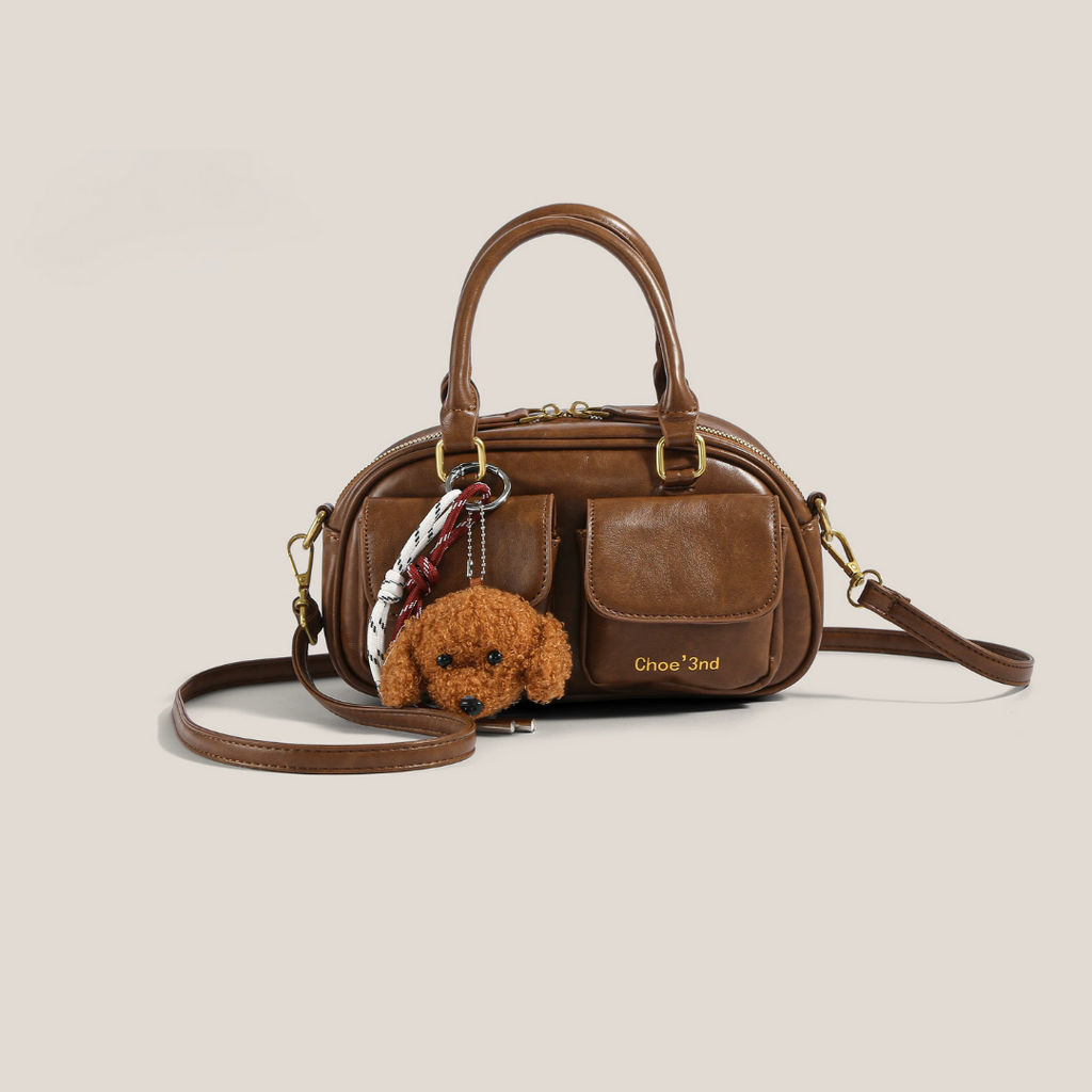 bolso de mano compacto con bolsillo frontal. Phoebe