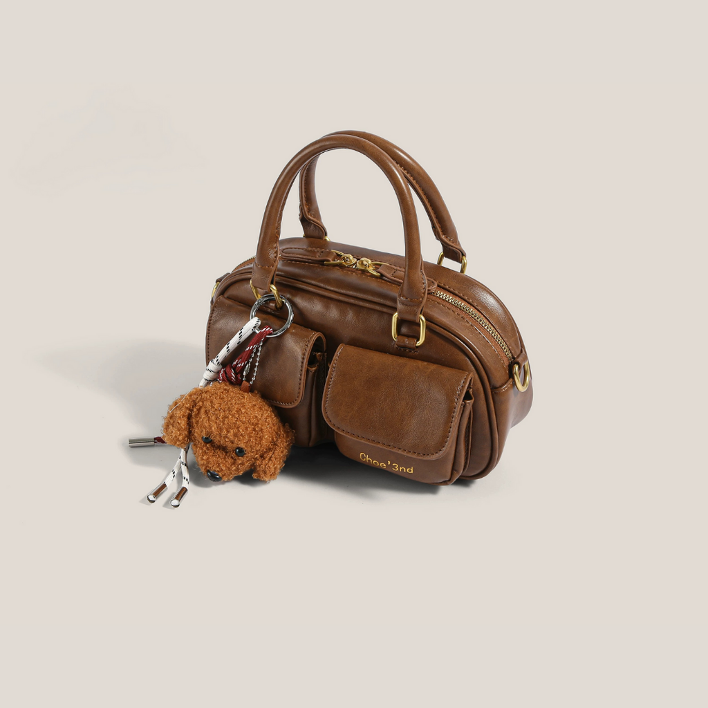 bolso de mano compacto con bolsillo frontal. Phoebe