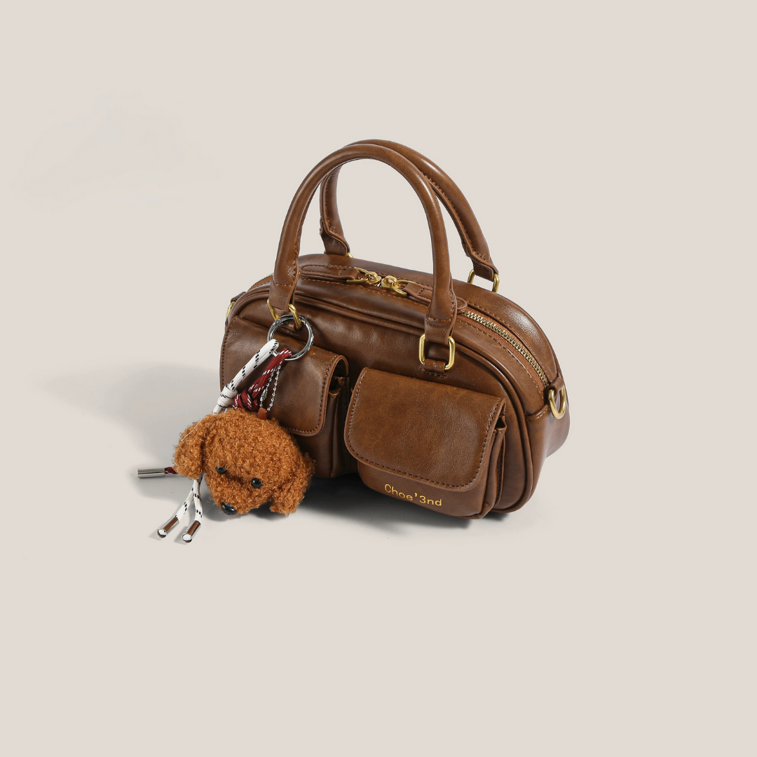 bolso de mano compacto con bolsillo frontal. Phoebe