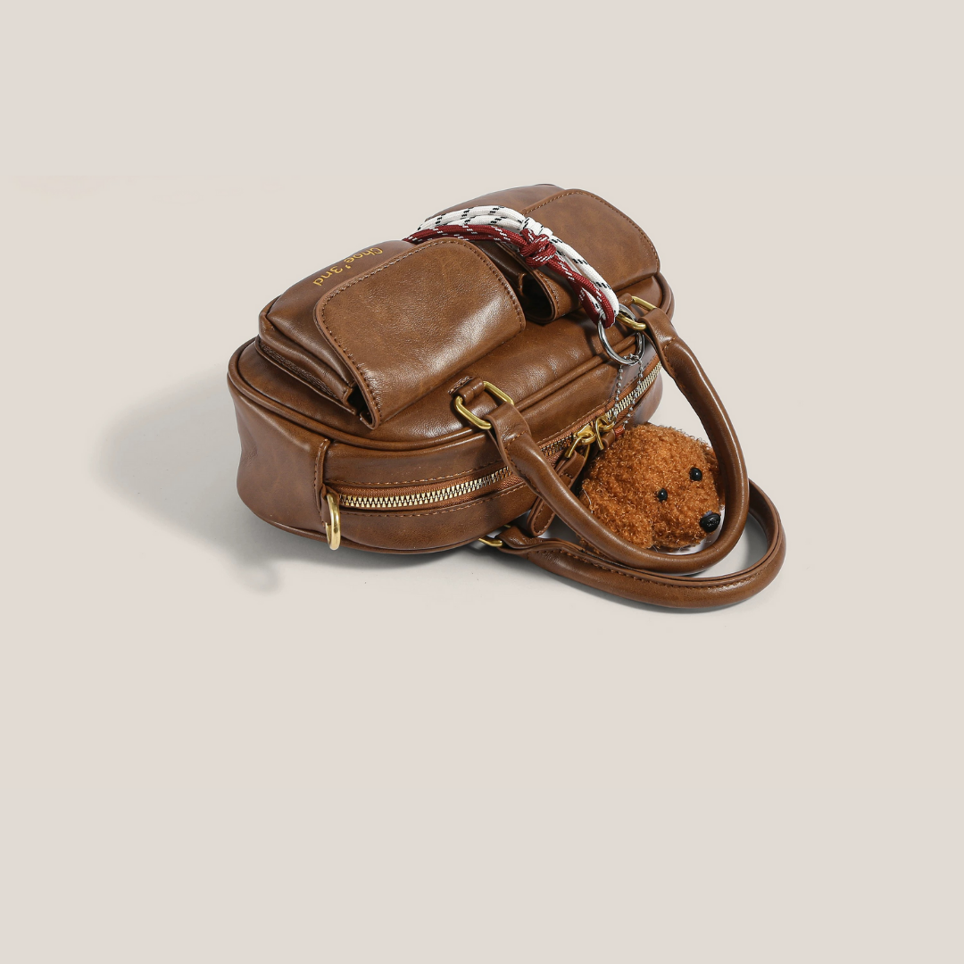 bolso de mano compacto con bolsillo frontal. Phoebe